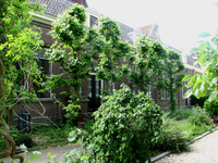819247 Gezicht op de voorgevel van de voormalige openbare lagere school Lange Nieuwstraat 7, op de Abraham Dolehof te ...